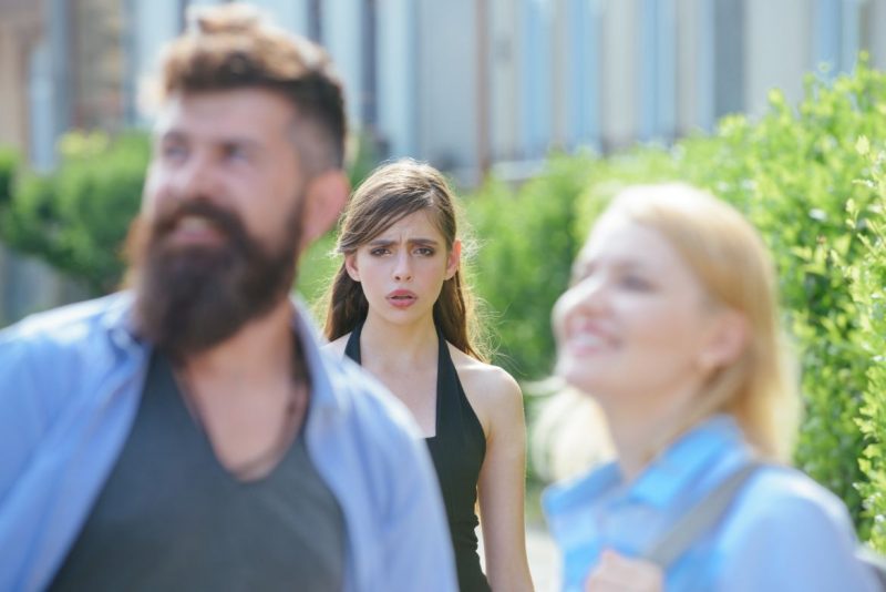 Woman Unhappy Behind Man