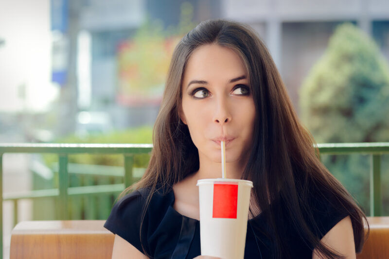 Young Woman Having A Summer Refreshing Drink Outside