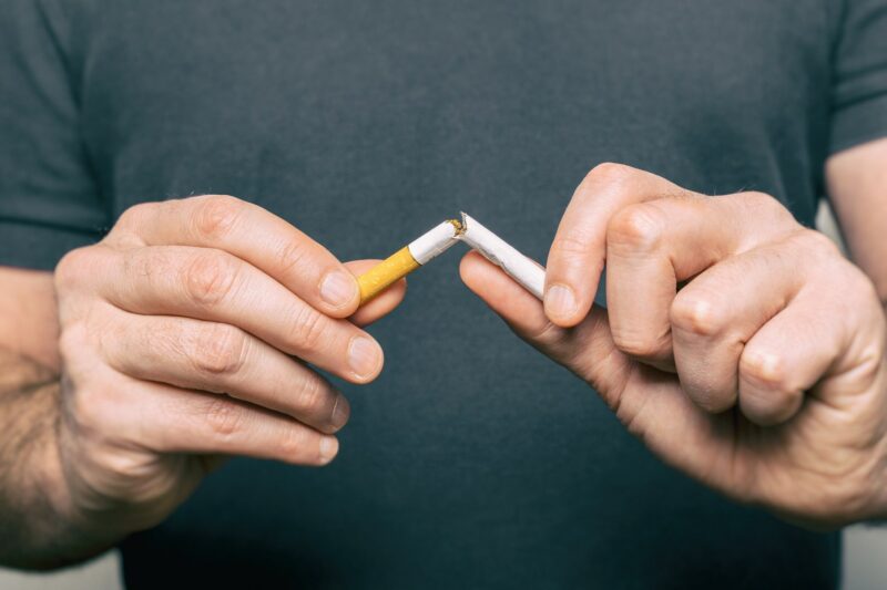 Quitting Smoking Male Hand Crushing Cigarette