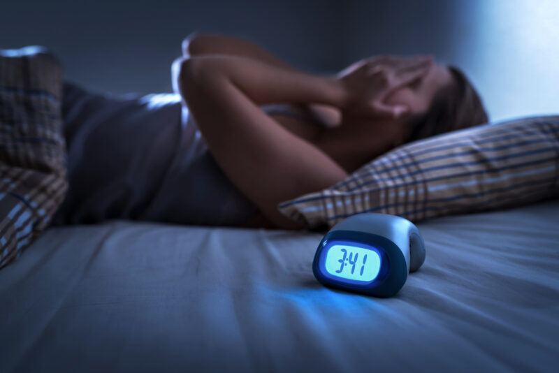 Mengenal Trik Tidur ala Militer, Tertidur dalam 2 Menit 2 Sleepless Woman Suffering From Insomnia, Sleep Apnea Or Stress. Tired And Exhausted Lady. Headache Or Migraine. Awake In The Middle Of The Night. Frustrated Person With Problem. Alarm Clock.